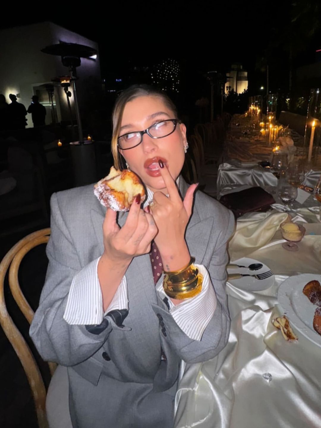 Bella Hadid shares an Instagram story of Hailey Bieber in a suit eating a doughnut