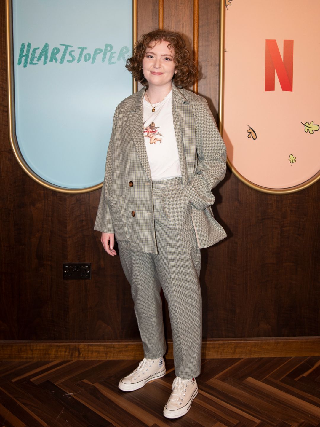Heartstopper's creator Alice Oseman stood smiling at an exclusive Netflix event