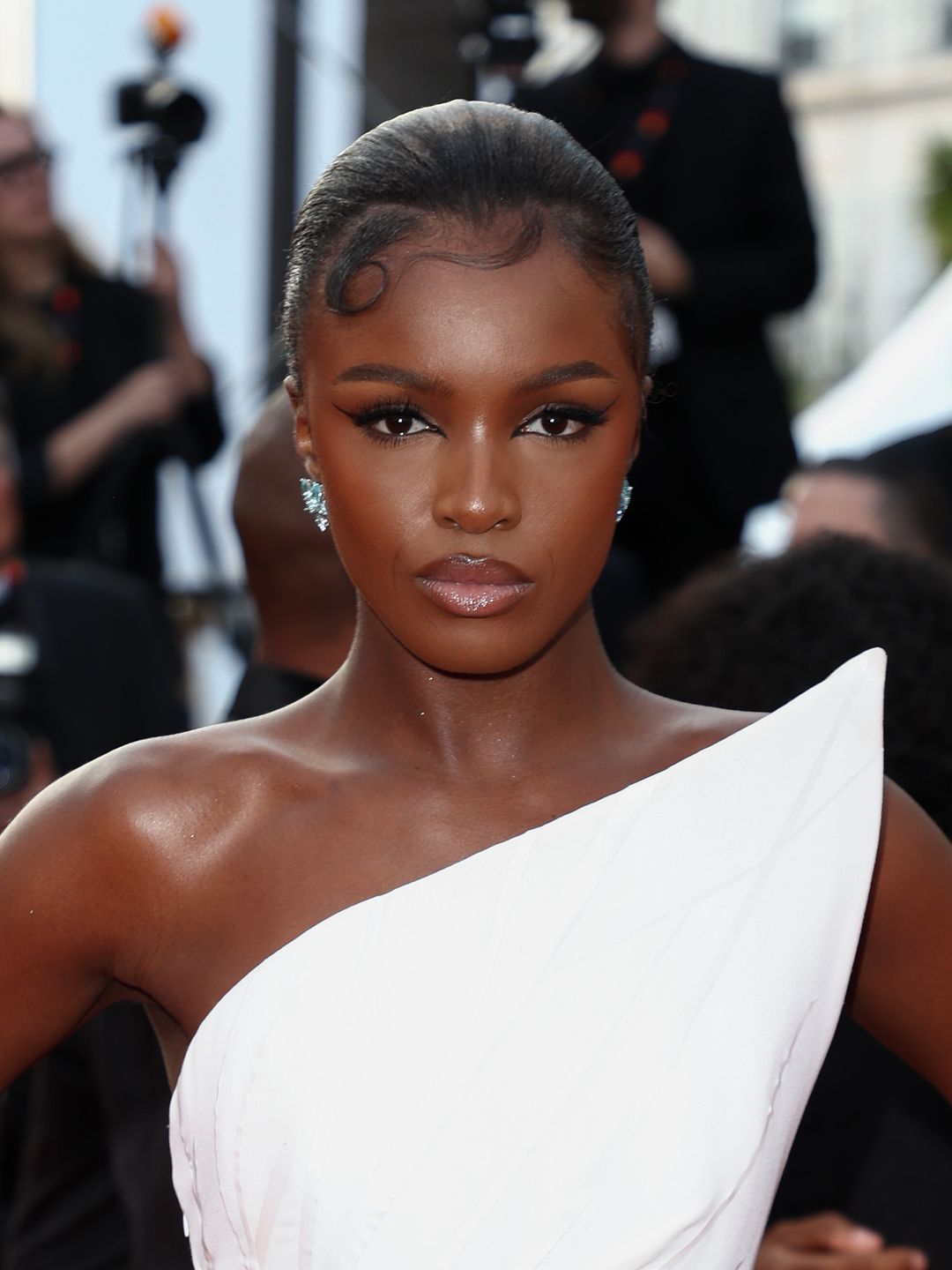 Leomie Anderson with glossy lips and kiss curls 