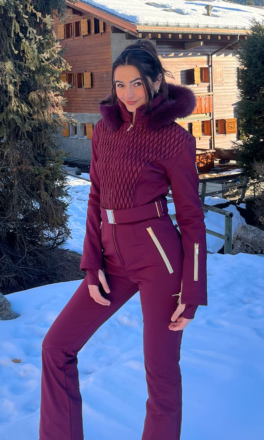 girl in red ski suit in mountains