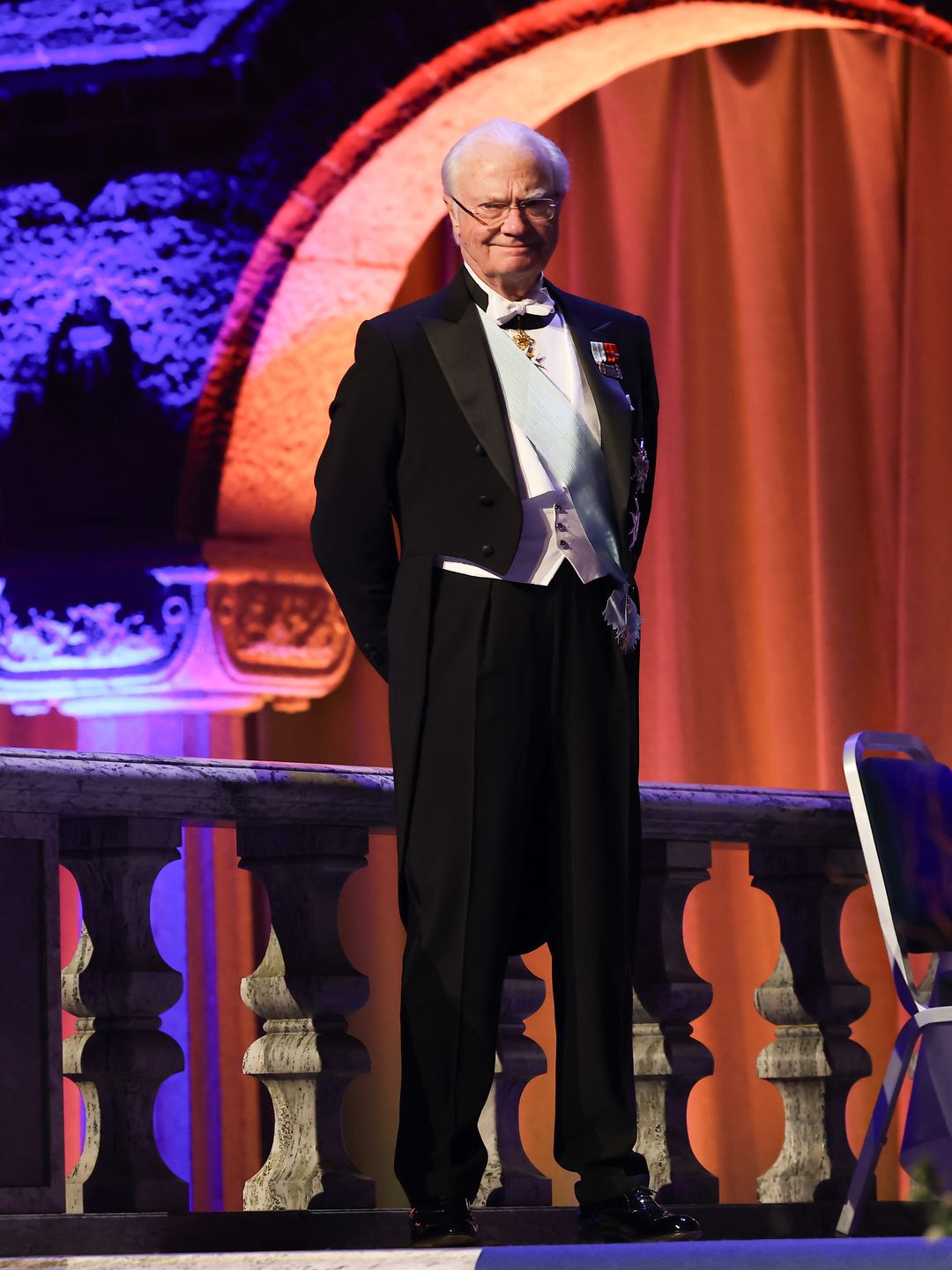 Full-body shot of King Carl Gustaf in a black suit