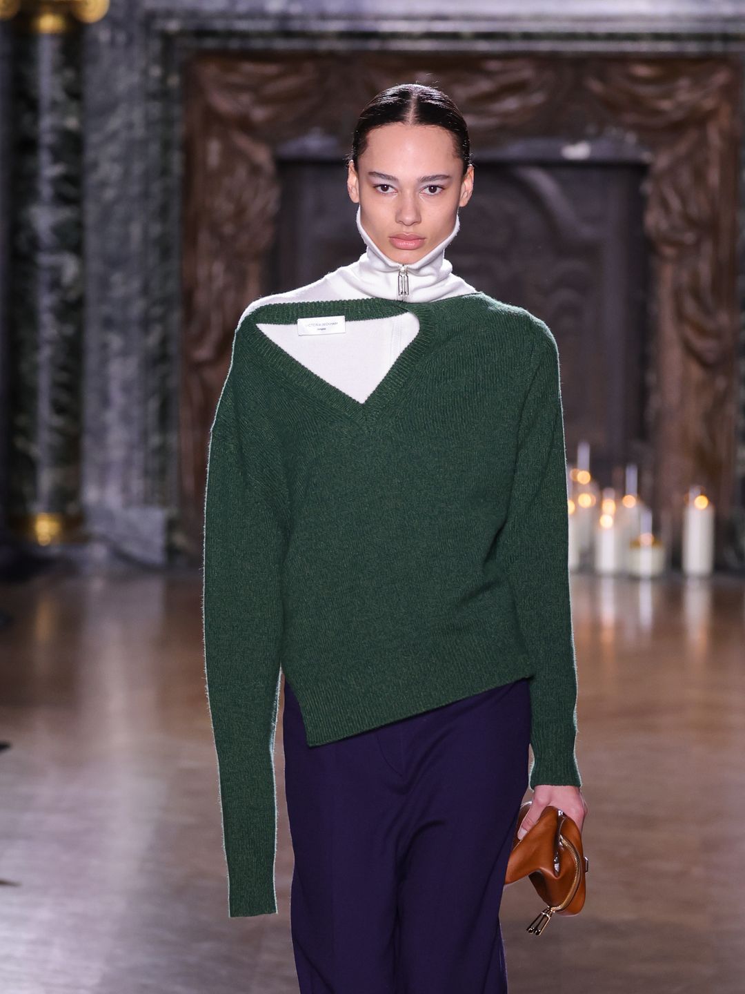 A model walks the runway during the Victoria Beckham Womenswear Fall/Winter 2024-2025 show in a green jumper