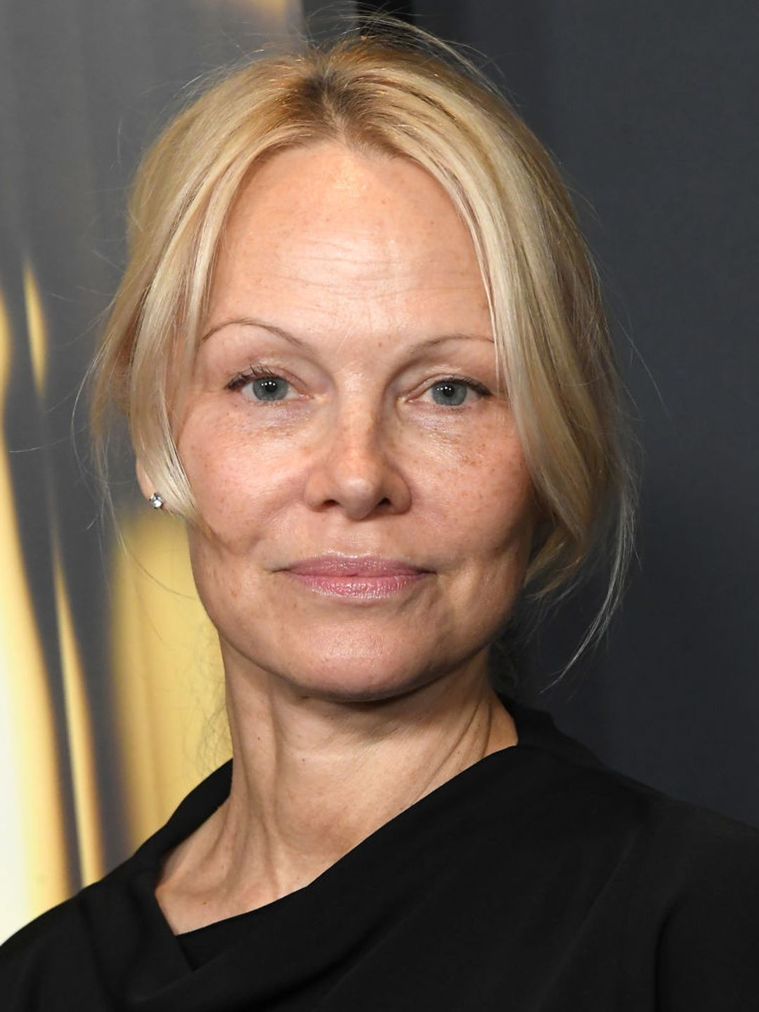 Pamela Anderson arrives bare-faced at the 2024 Governors Awards.