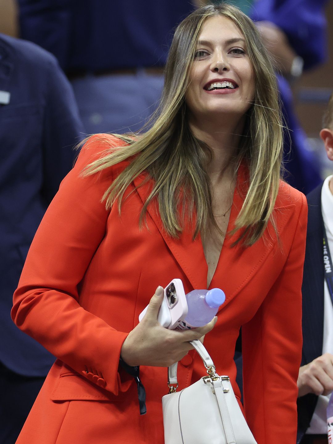 Maria Sharapova in an orange-red suit at the US Open 