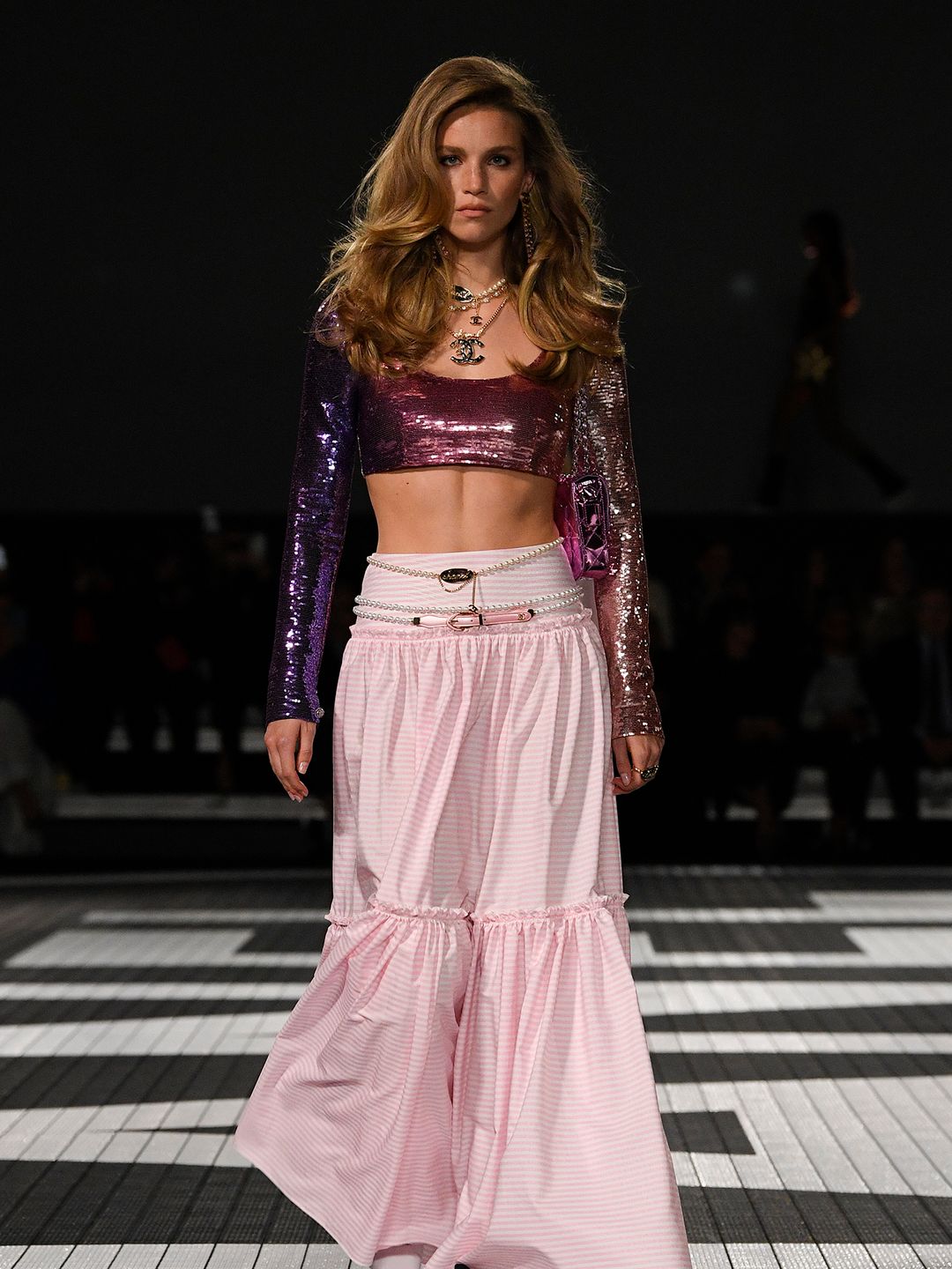 A model sports a Cindy Crawford-level blow dry with a shiny ombré crop top 