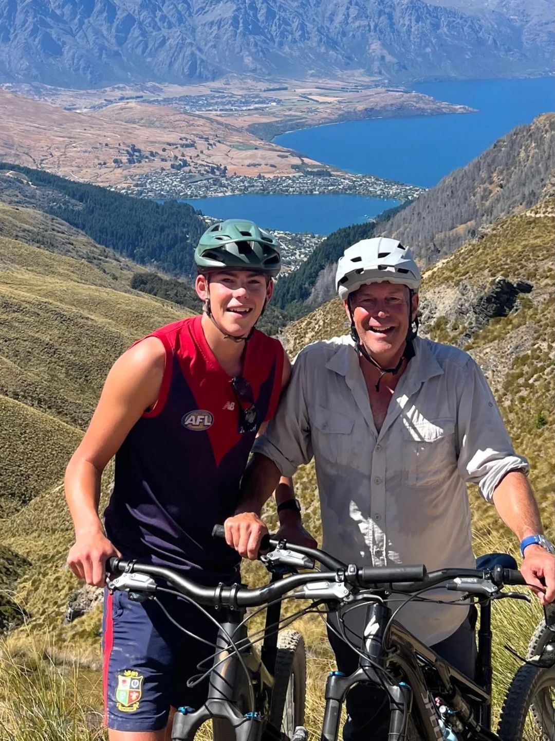 father and son riding on bikes in new zealand 