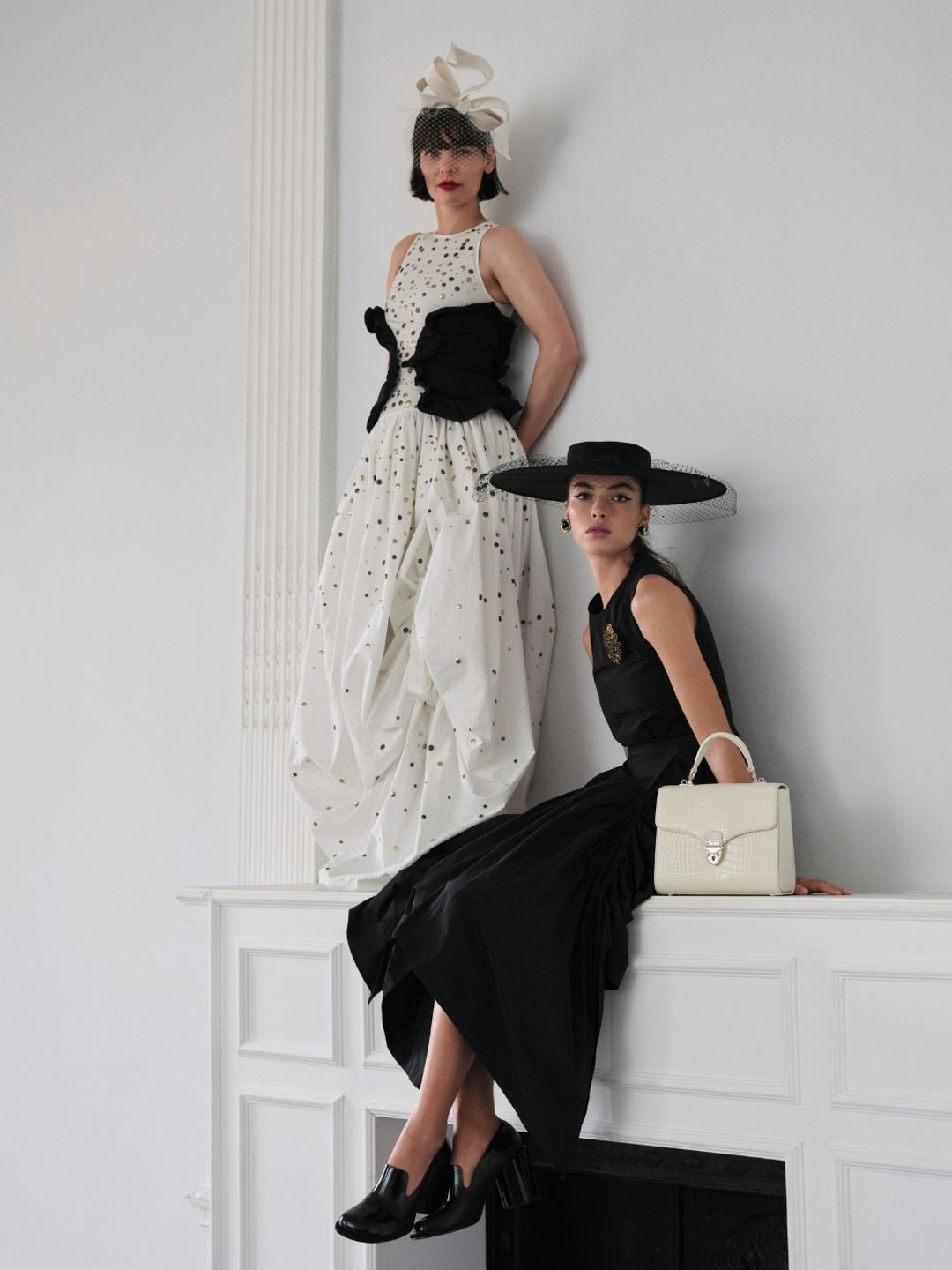 Two models pose in dresses as part of Royal Ascot's new lookbook
