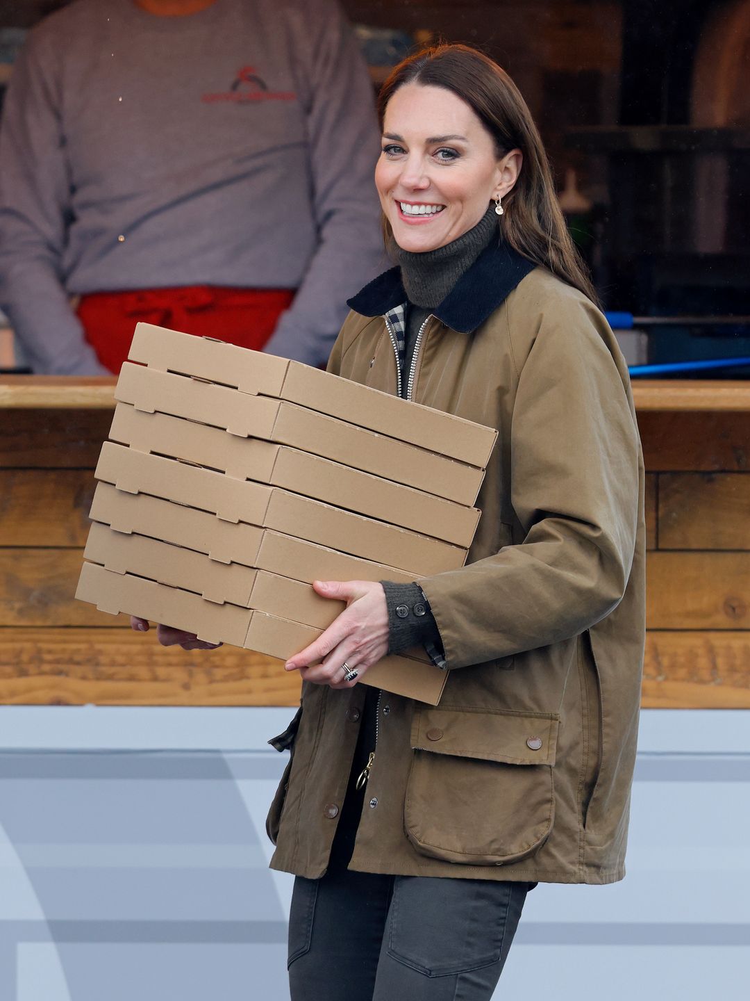 woman carrying boxes of pizza 