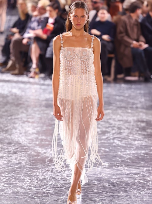 A model walks the runway during the Jean Paul Gaultier Haute Couture Spring/Summer 2024 show in a sheer white dress