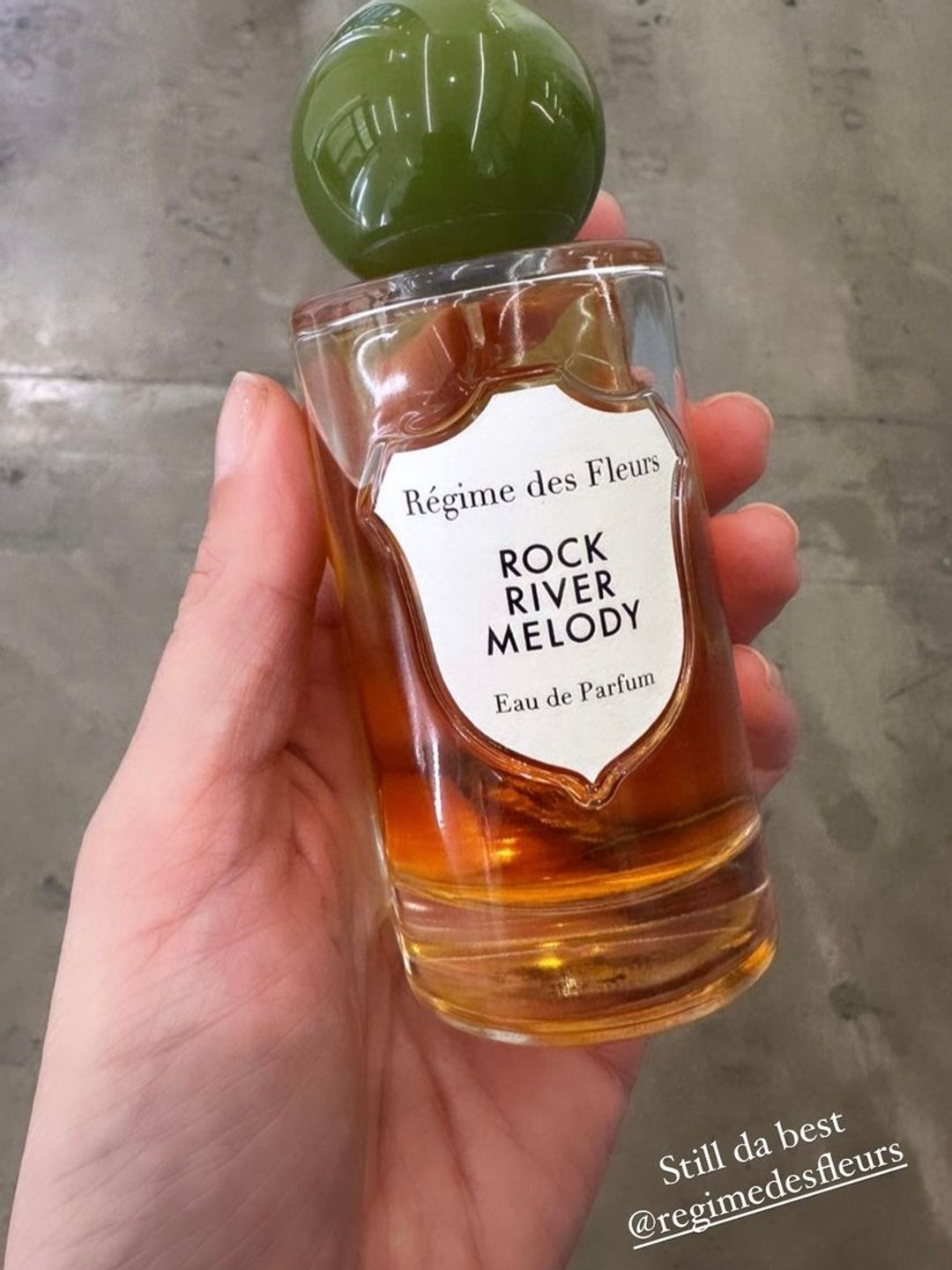 Bottle of Rock River Melody perfume in Alexa Chung's hand 