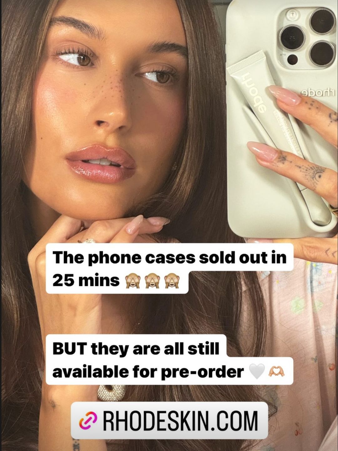 Hailey Bieber taking a selfie with her lip balm holder phone case 