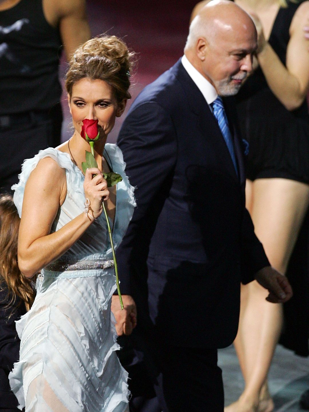 Singer Celine Dion (L) is escorted by her husband and manager Rene Angelil as she leaves the stage after the last performance of her show "A New Day..." at The Colosseum at Caesars Palace December 15, 2007 in Las Vegas, Nevada. Nearly three million people watched Dion perform 717 shows since it opened in March 2003.  (Photo by Ethan Miller/Getty Images for AEG Live/Concerts West)