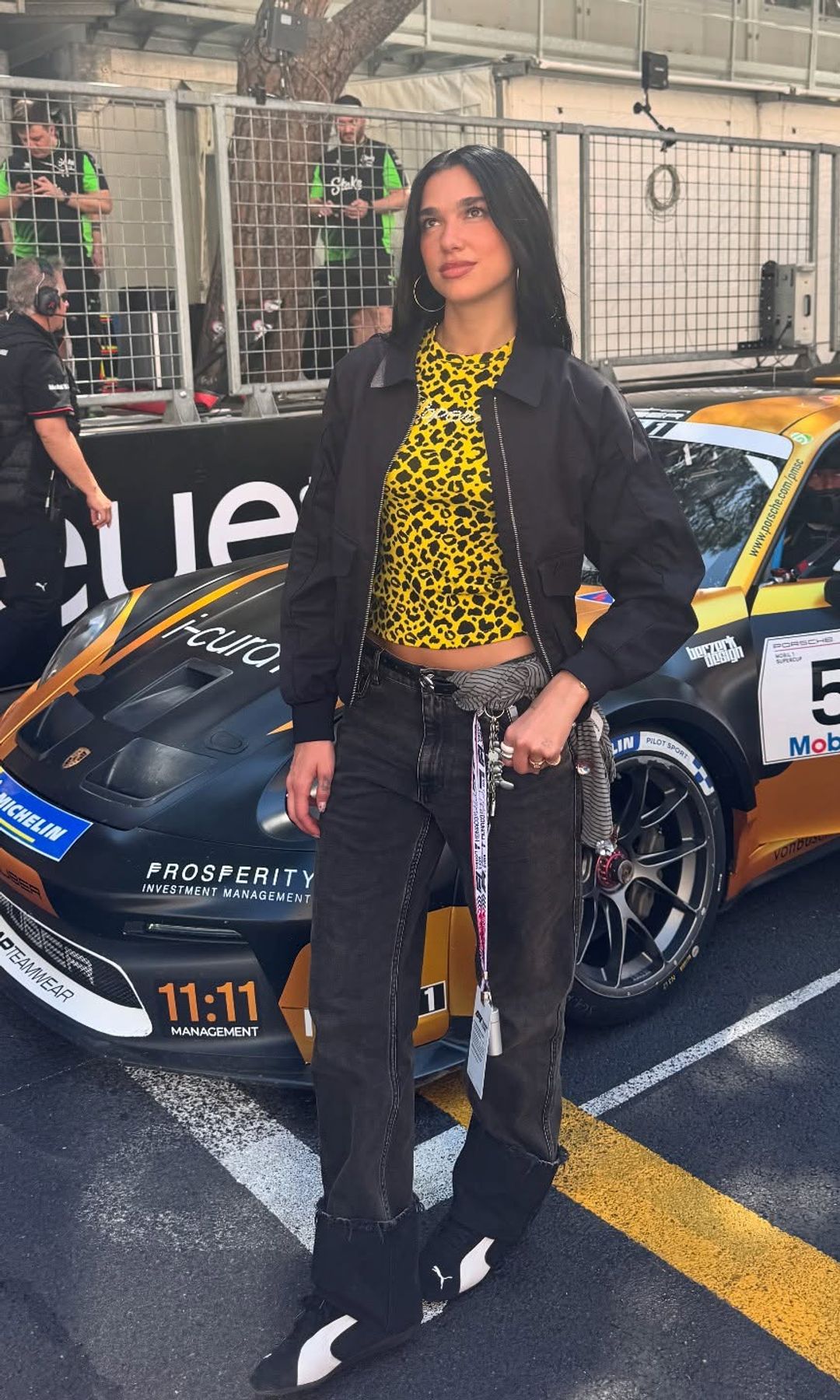 Dua Lipa poses in jeans and a leopard print t-shirt