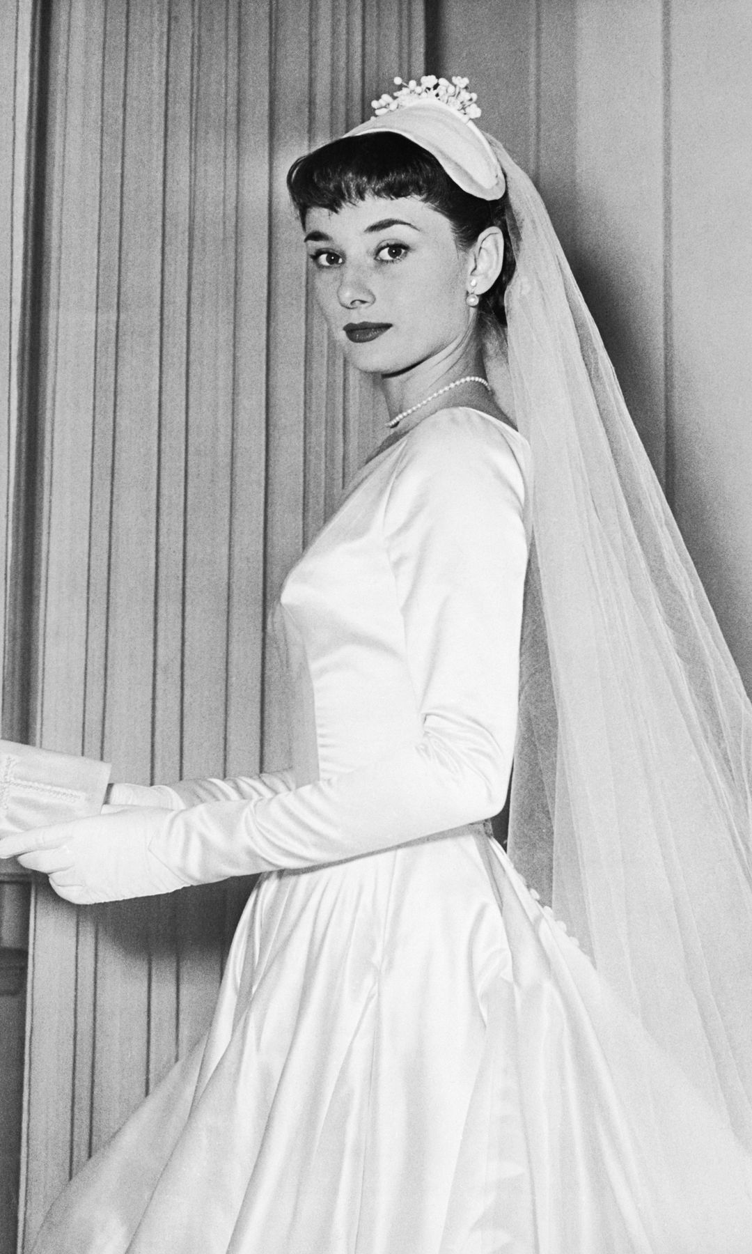 Audrey Hepburn wears the wedding gown designed by Zoe Fontana of Rome for her marriage to James Hanson.