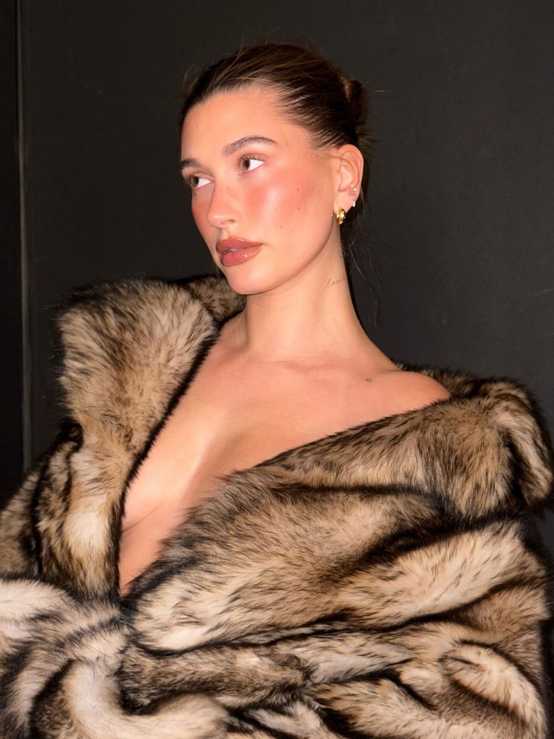 Hailey Biber poses for an Instagram photo in a fluffy faux fur coat 