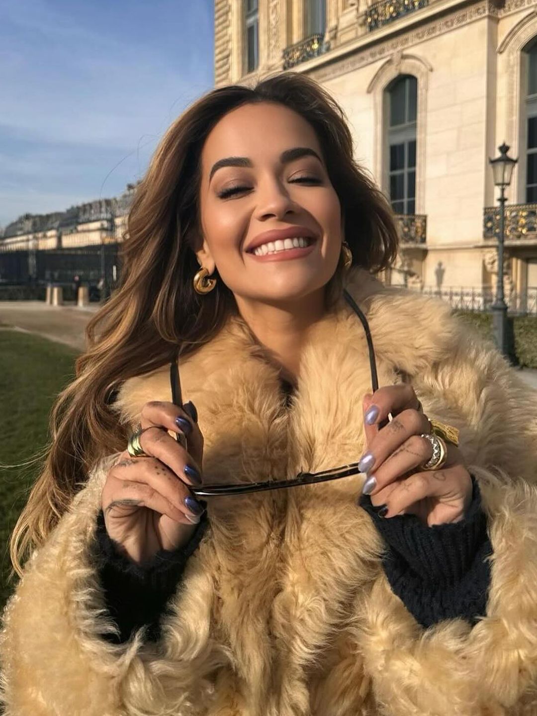 Rita Ora poses in a fur coat in Paris