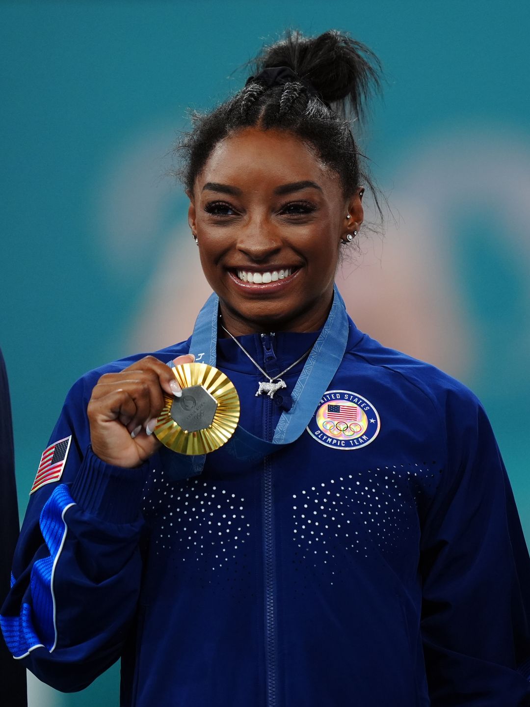 Simone Biles with her gold medal and 'GOAT' necklace following the Women's All-Around Final at the Bercy Arena