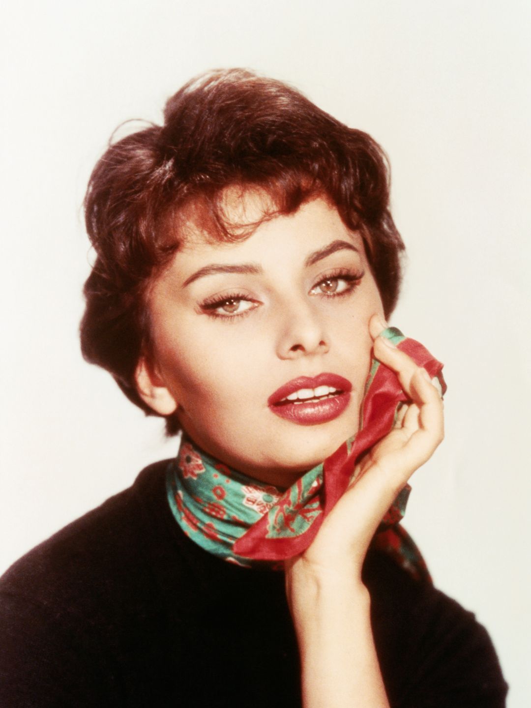 Sophie Loren wearing a green and red silky scarf around her neck 