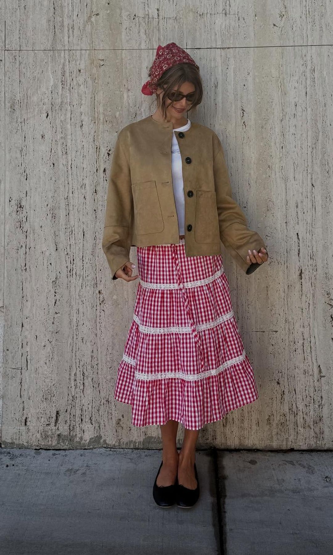 Olivia Jade in a red skirt and brown jacket 