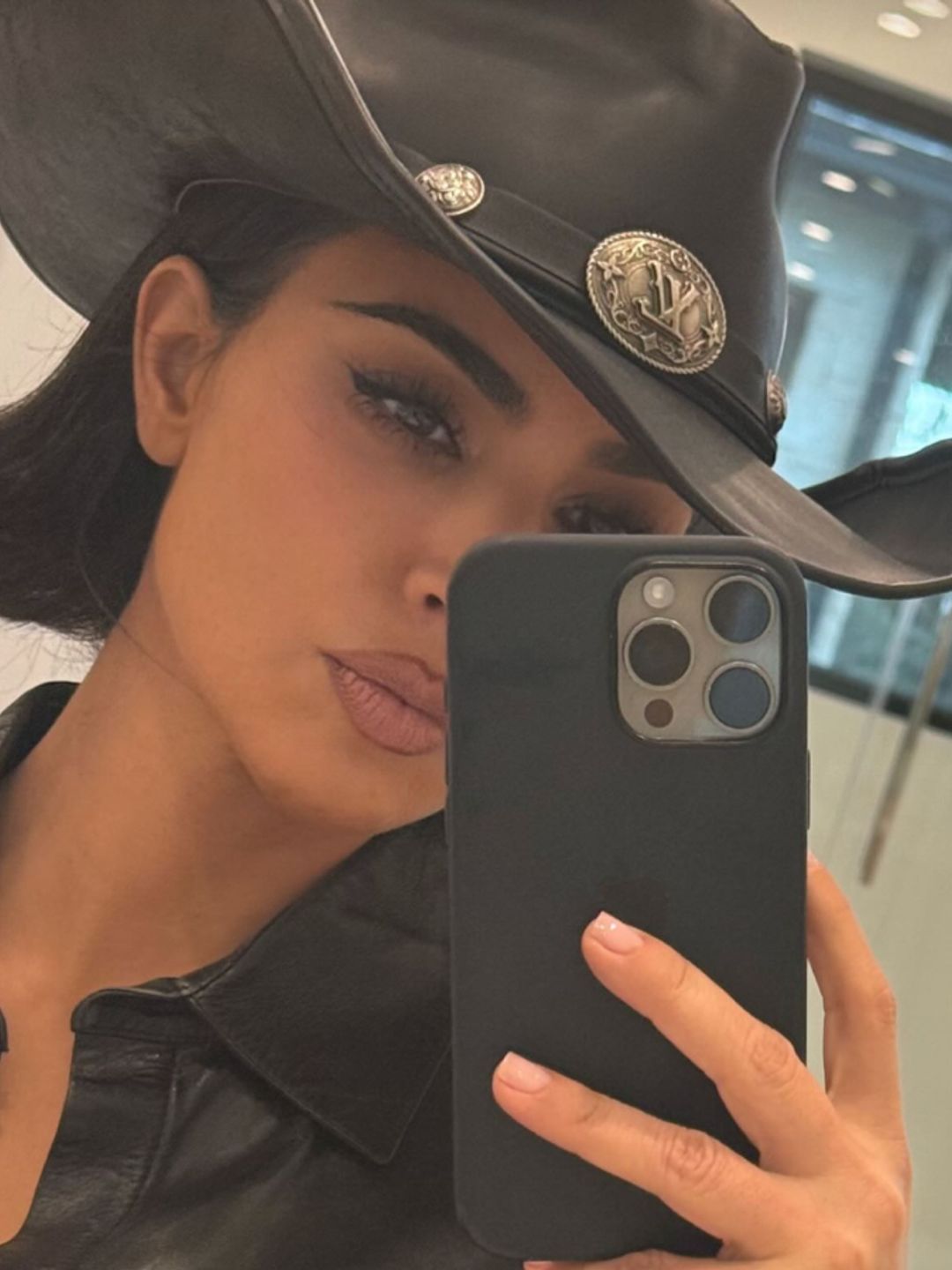 Kim Kardashian's stuns with a sleek jet black outfit and matching hair