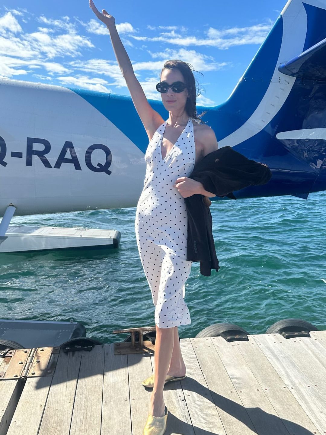 Alexa Chung poses in a polka dot dress while on holiday
