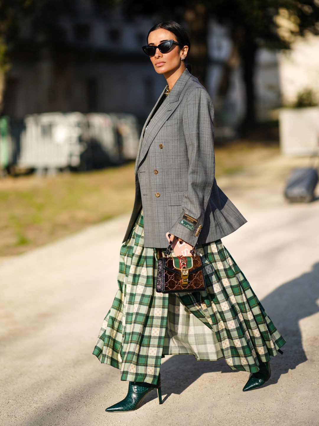 A Fashion Week guest wears hers with a slate grey blazer 