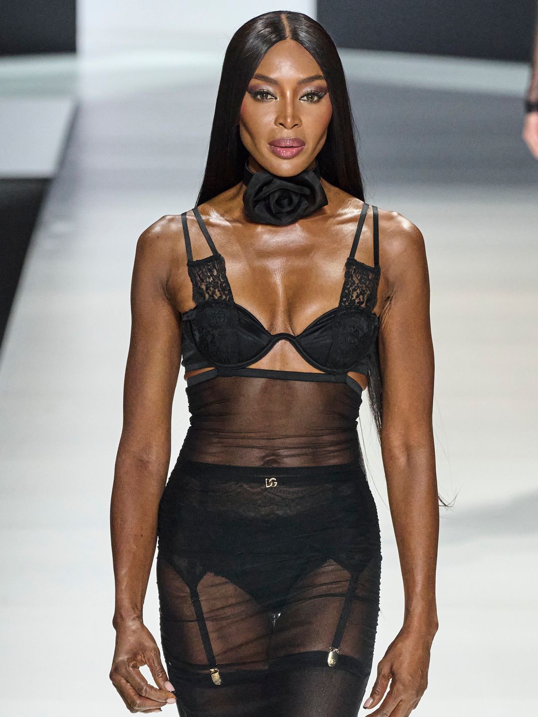Naomi Campbell wearing a black lingerie set walking for Dolce & Gabbana SS24