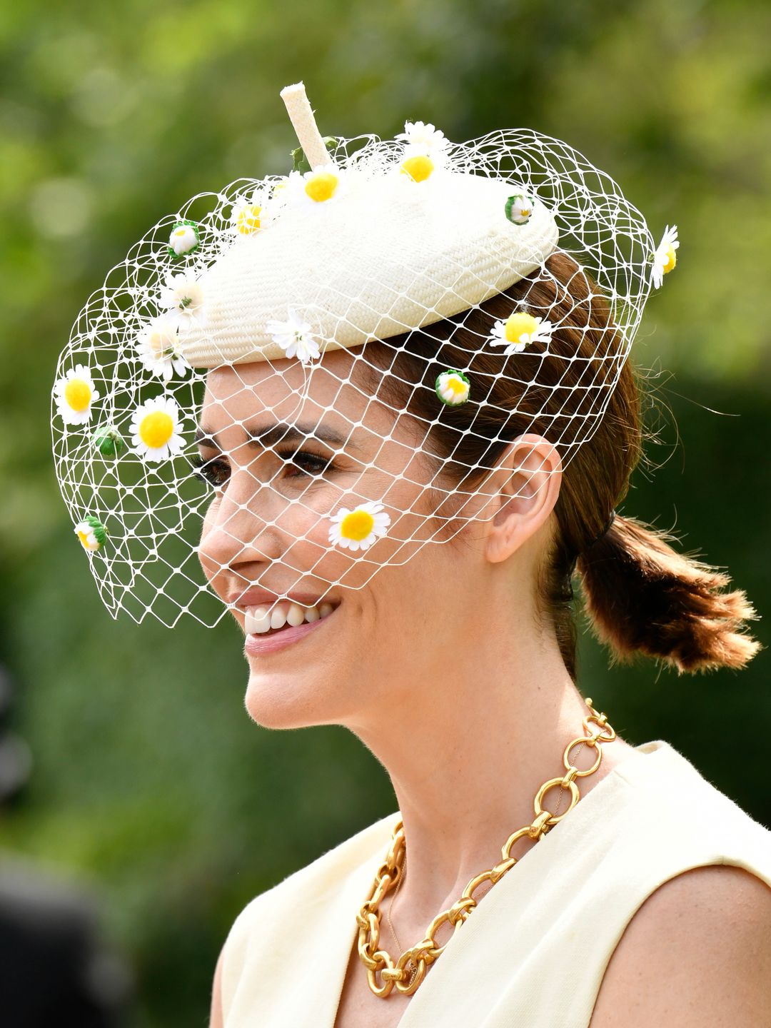 Louise Roe with a daisy fascinator and a low ponytail 