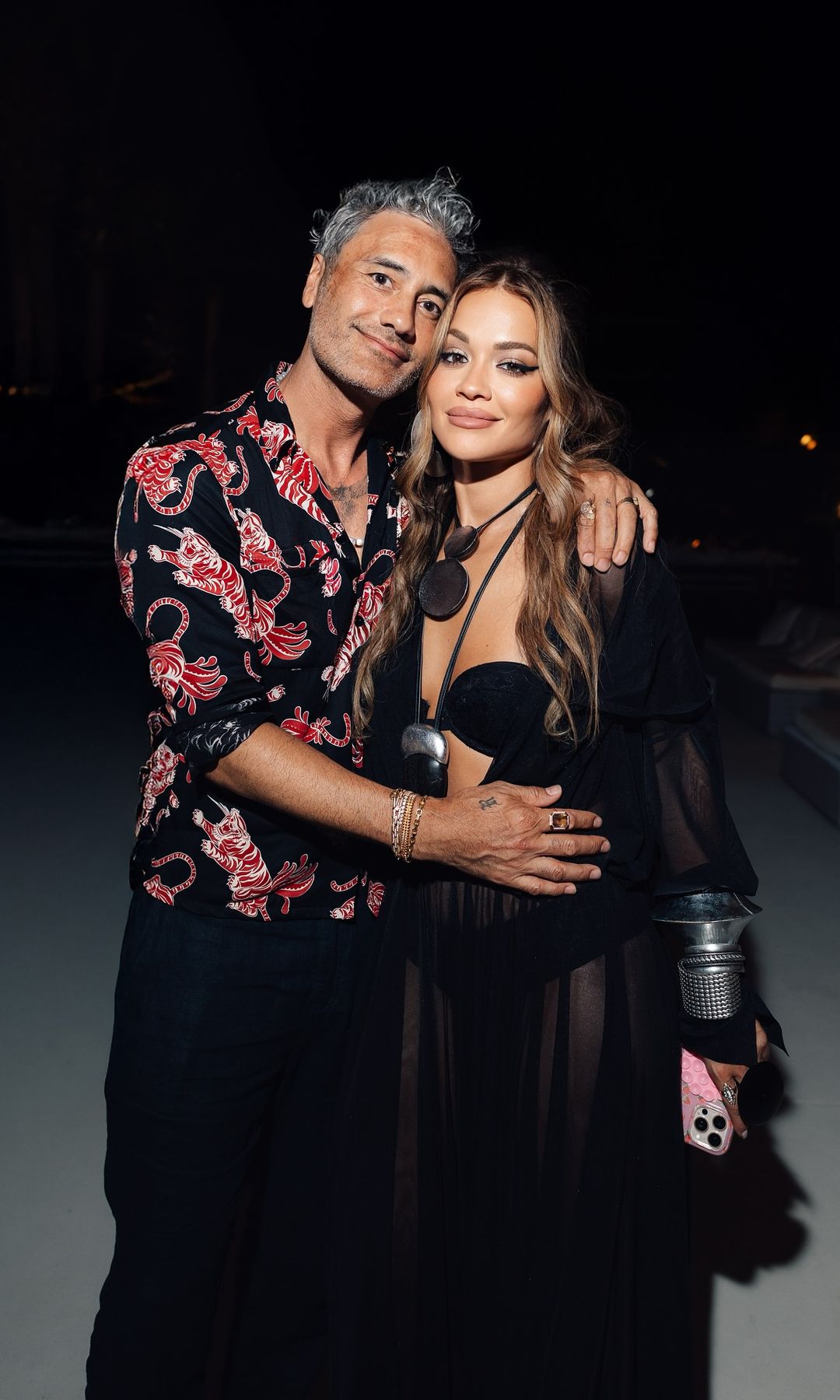 Rita Ora and Taika Waitit pose for a photo hugging