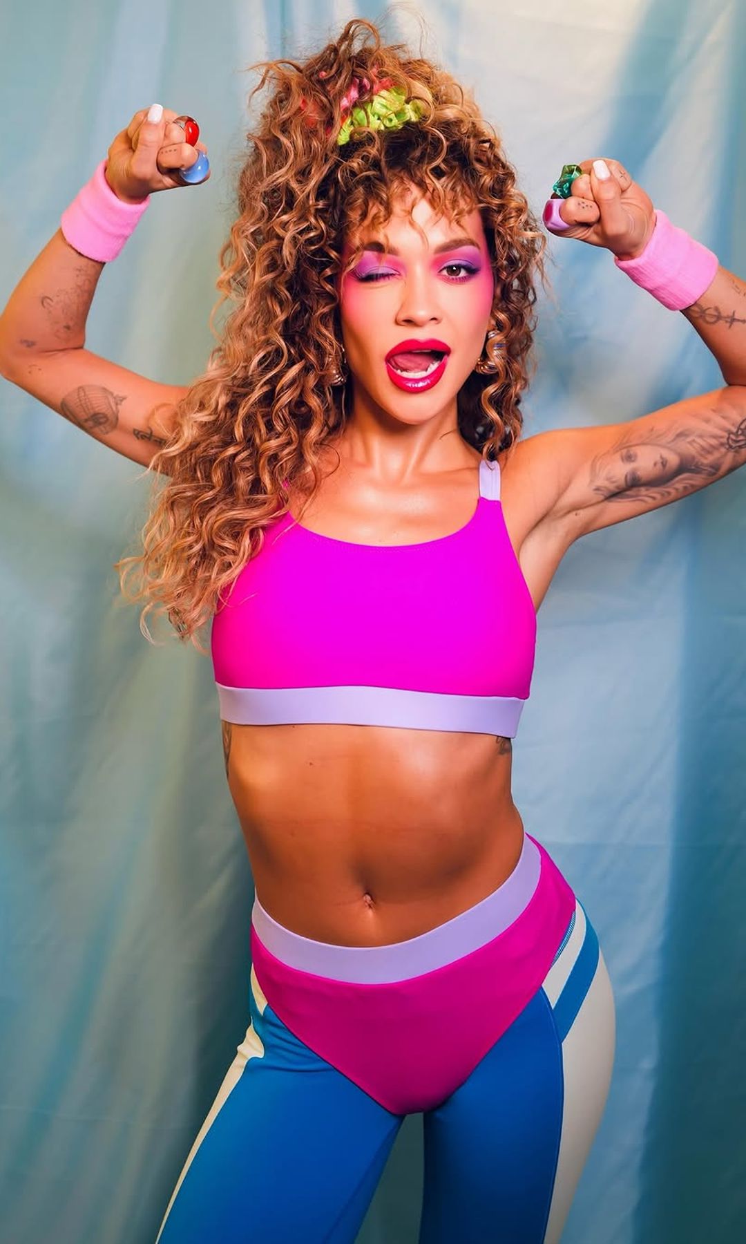 Rita Ora is kitted out with colourful 80s exercise gear 