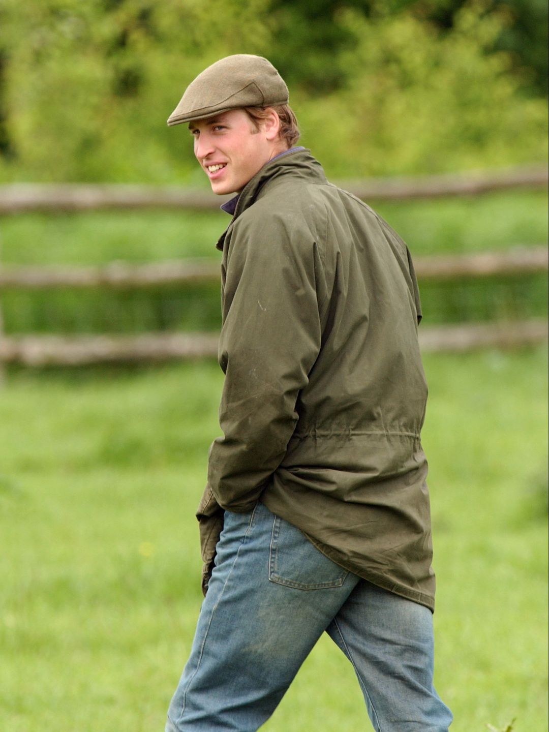 man walking in jeans, jacket and flat cap 