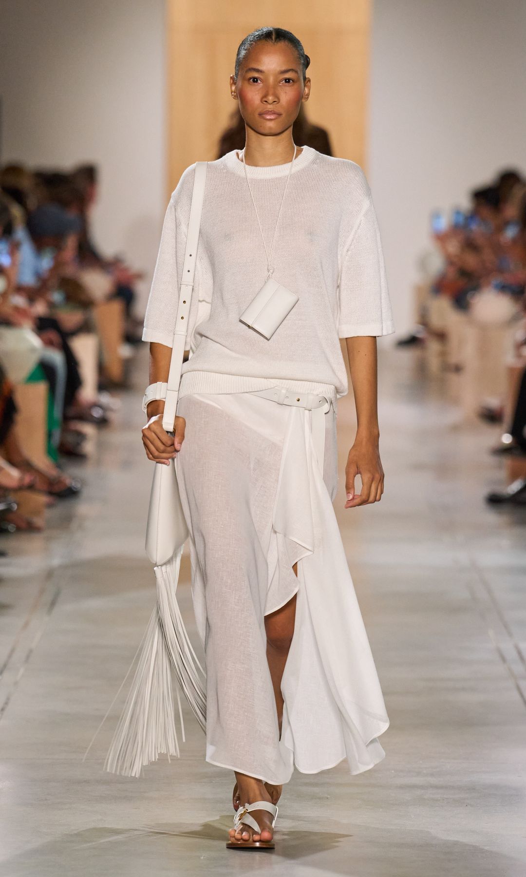 A model walks down the runway at Michael Kors in head to toe white