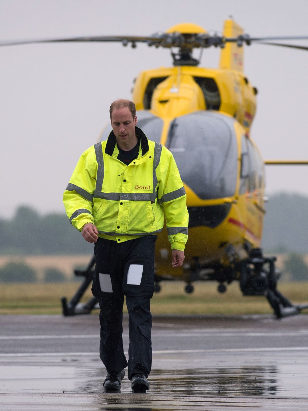 Prince William walking away from an air ambulance