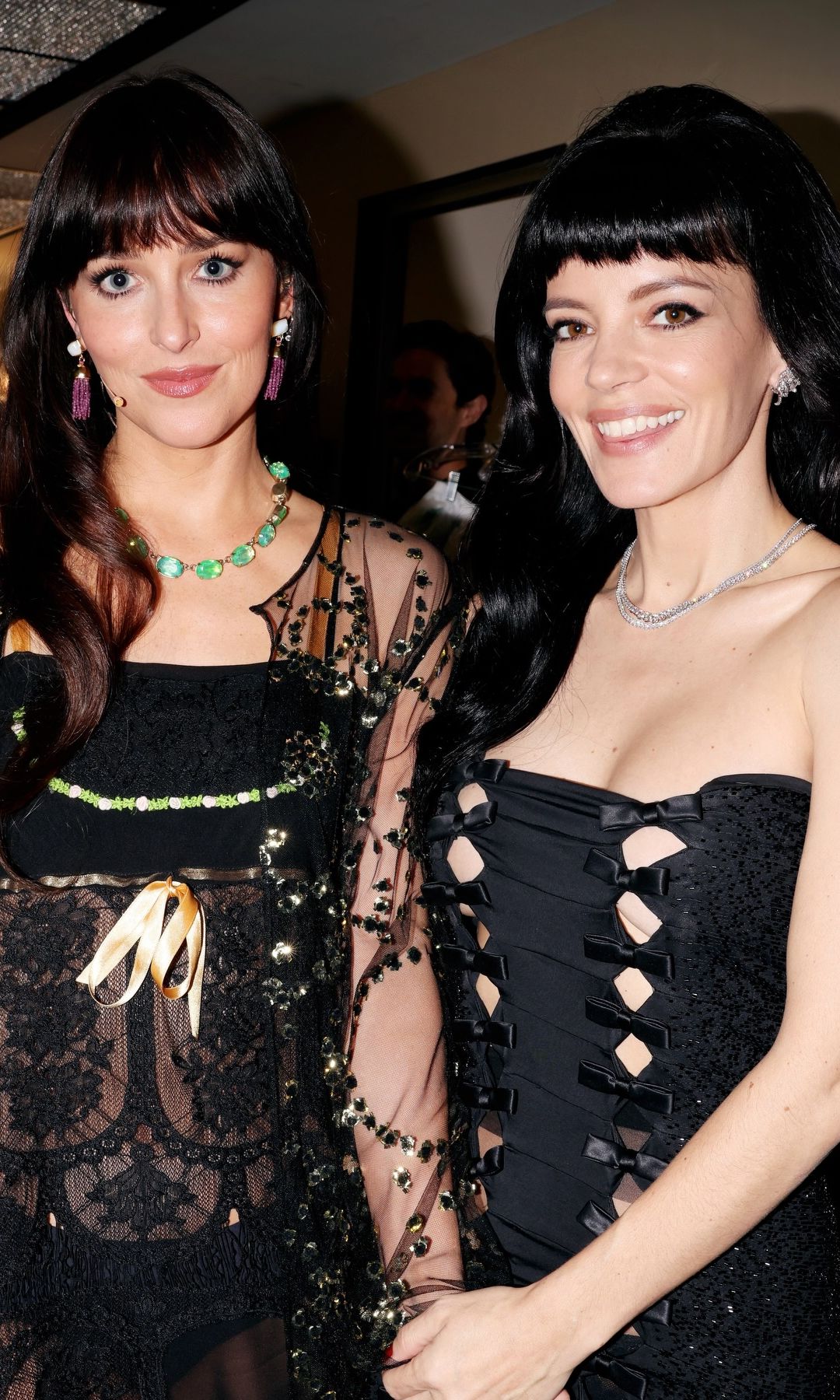 Lily Allen and Dakota Johnson pose at SNL in black dresses