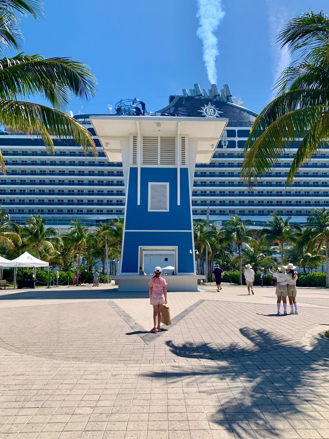 A view from the side of a cruise at deck with passangers at their destination