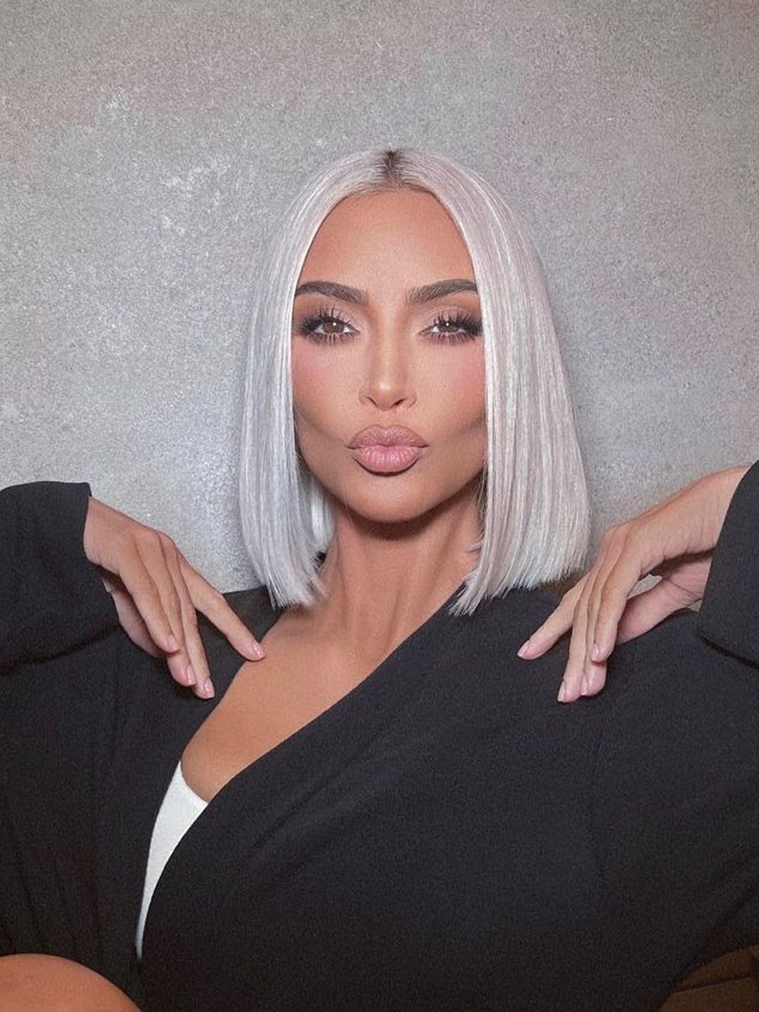 Kim Kardashian with platinum hair in a curtain cut 