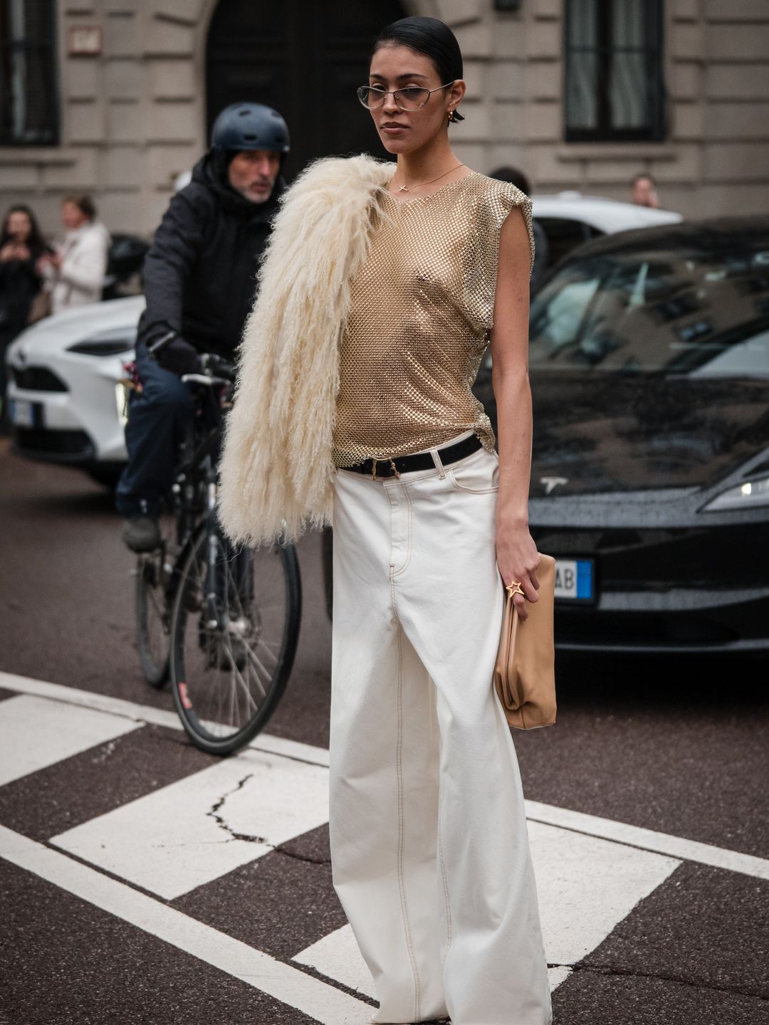 Fashion week guest wearing white jeans with sheer top 