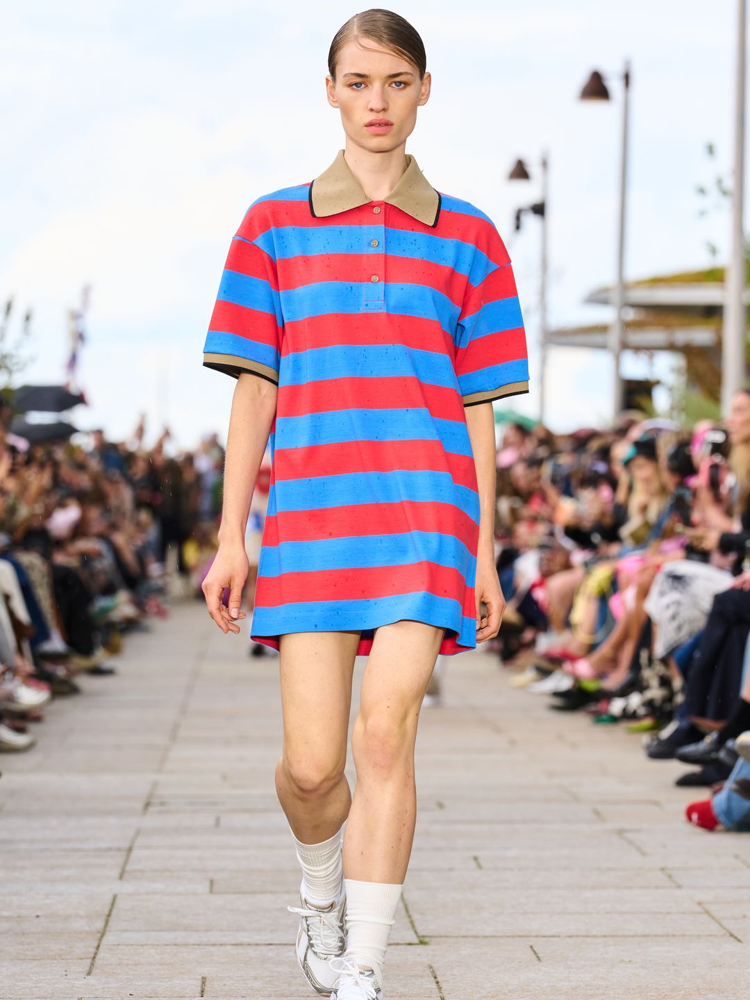 A blue and red rugby shirt dress paired with whit socks and trainers at Marimekko