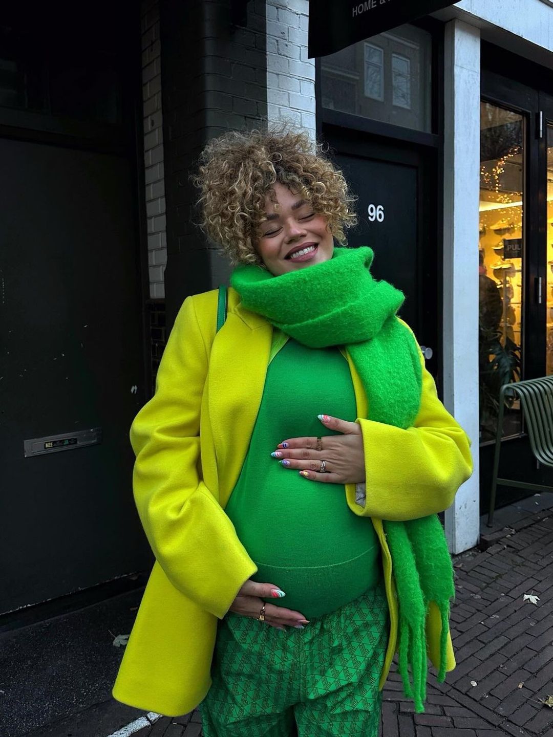 Influencer Celeste Evans poses in a full green outfit 