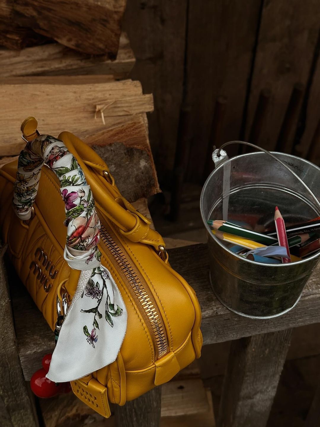 Gigi Hadid shares a close up pf her yellow Miu Miu bag