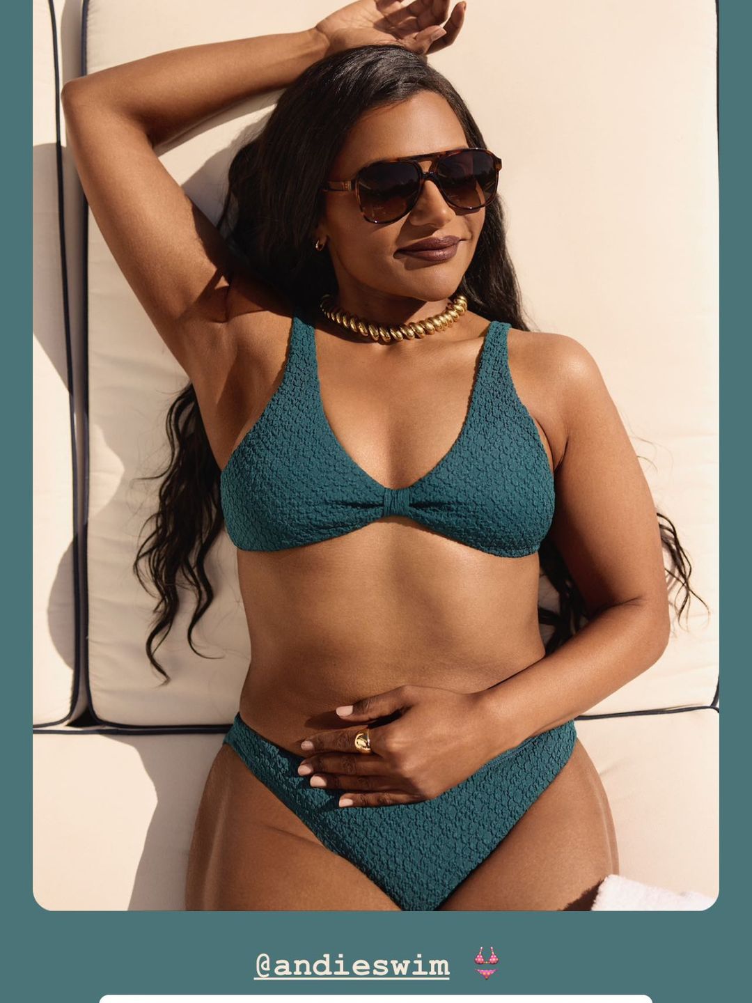 Mindy Kaling lying on a sunlounger in a dragonfly green bikini and sunglasses