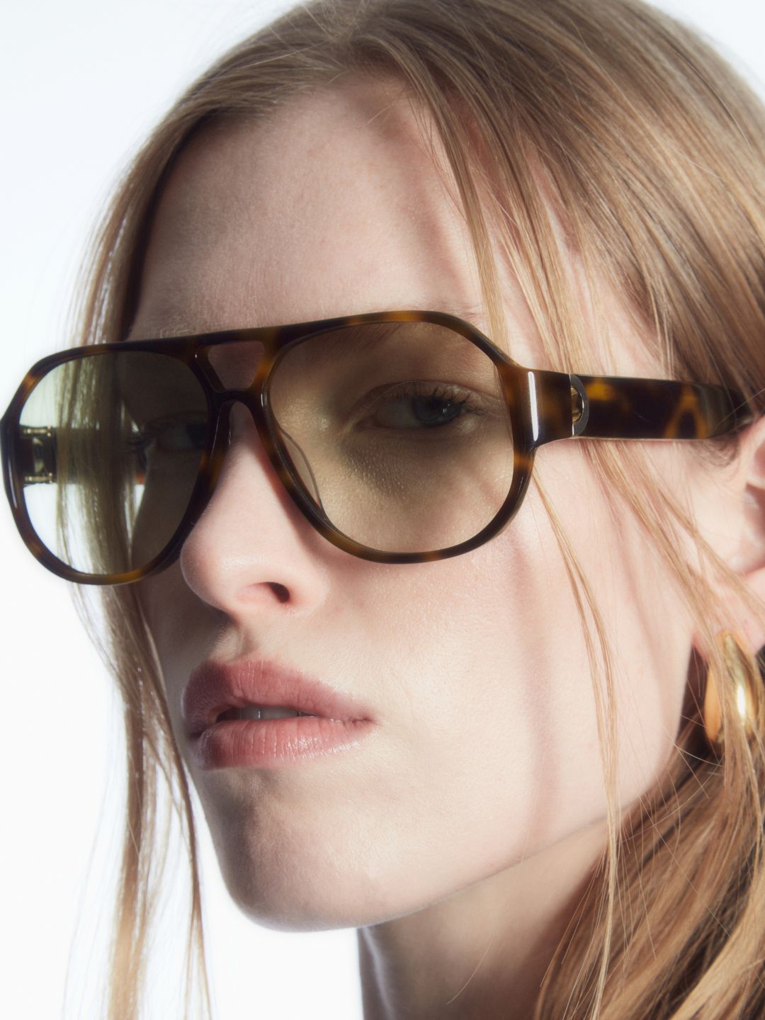 Model wearing Linda Farrow x Cos' Flight glasses 