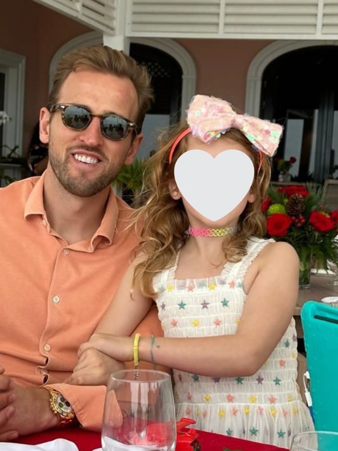 Harry Kane and a young girl at a restaurant