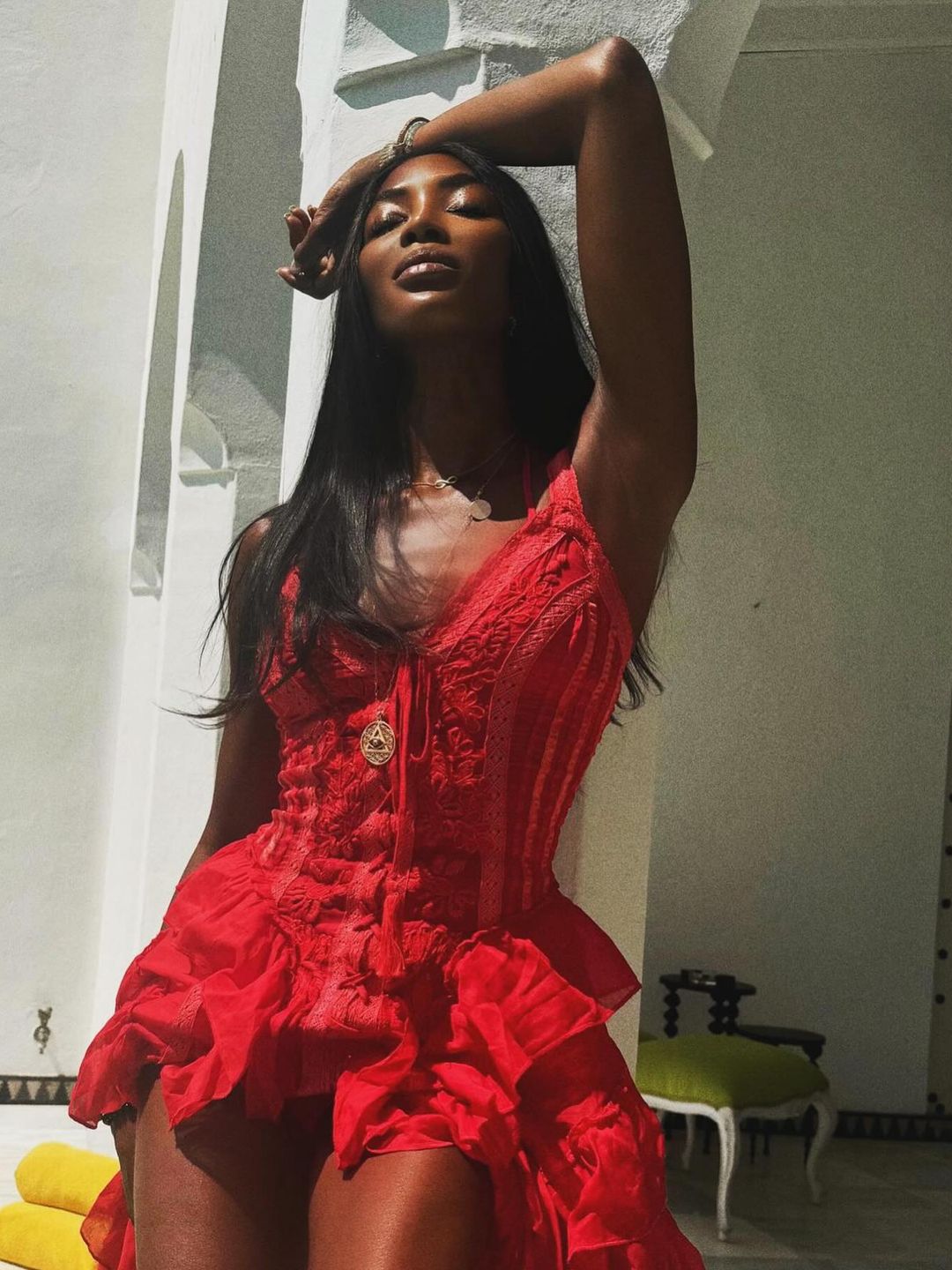 Naomi Campbell poses in a red mini dress on her Instagram