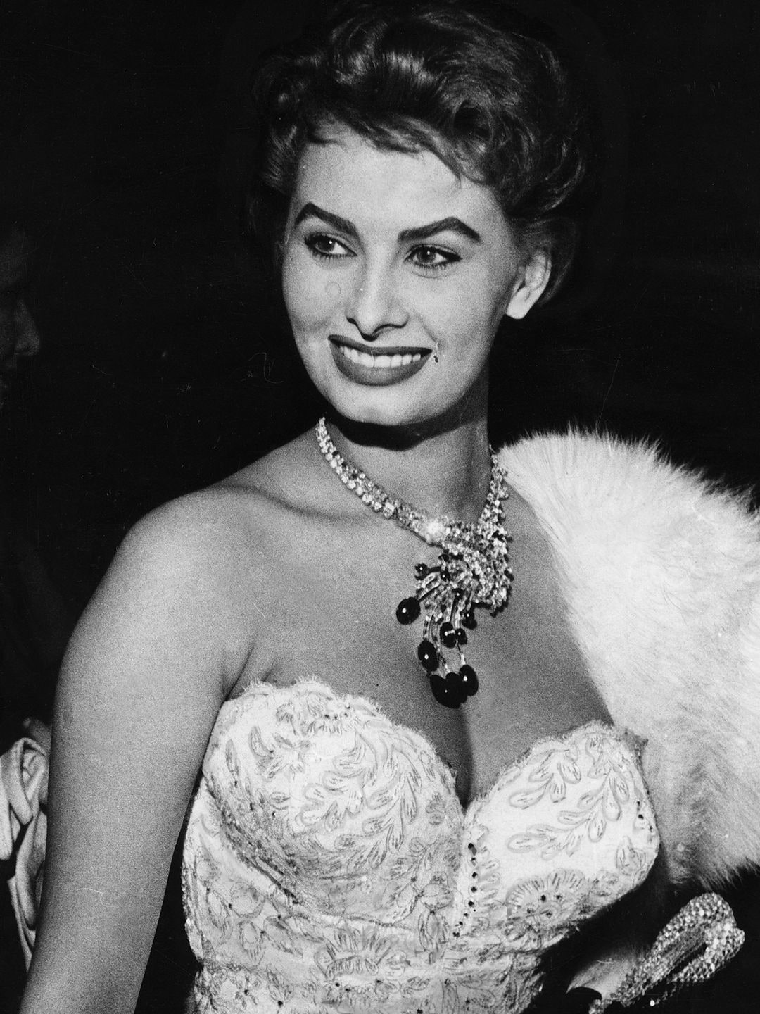 Sophia Loren wearing a strapless corset dress with a decadent necklace 