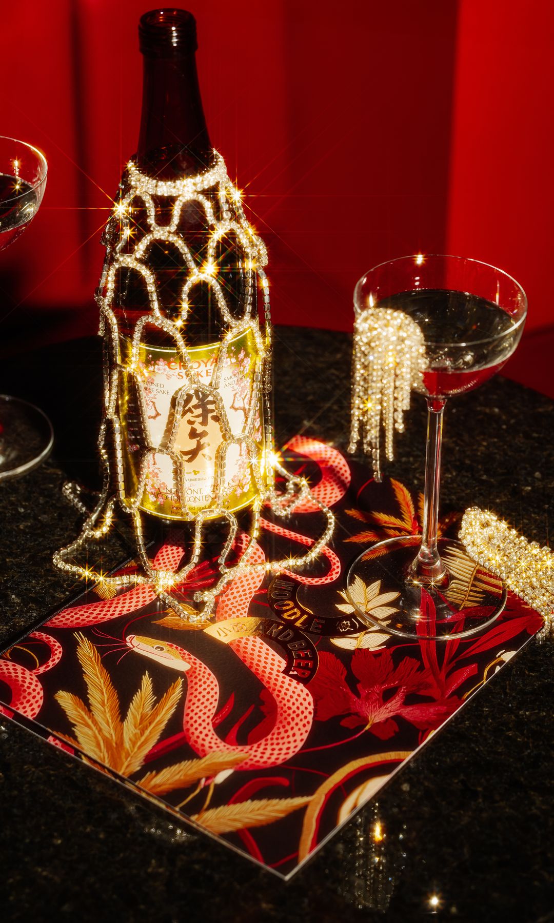 A photo of a champagne bottle and glass at Noodle & Beer SOHO