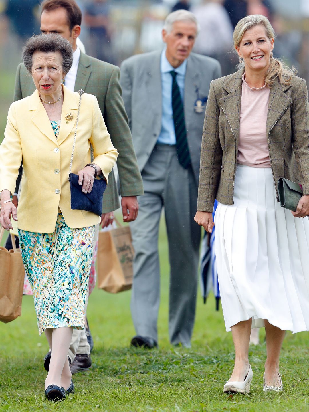 sophie and princess anne walking on grass 
