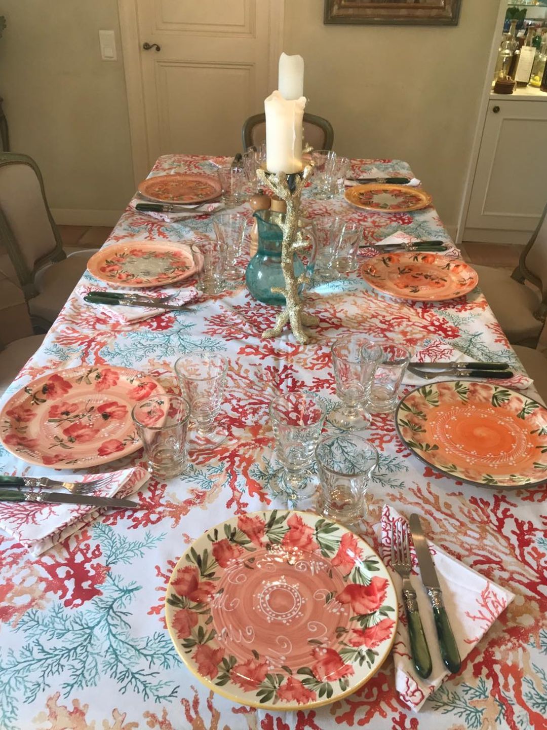 table with plates, candles and glasses