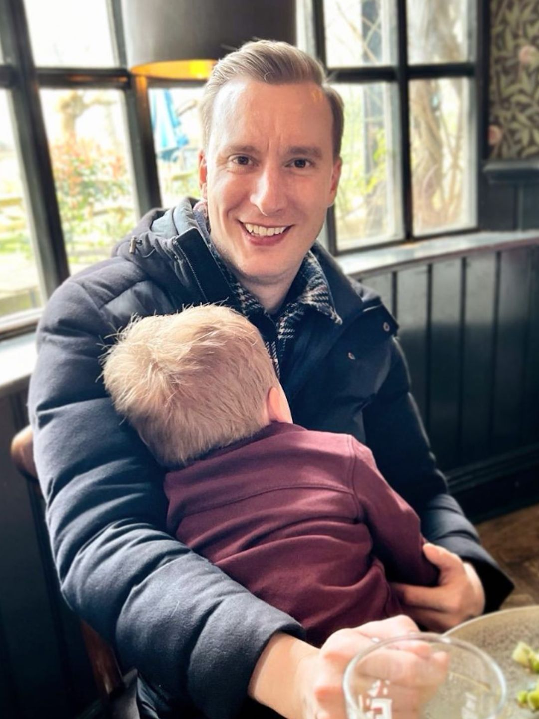 Paul Brand with his son in a pub