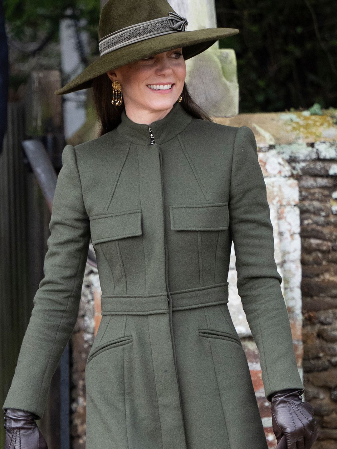 Kate Middleton wearing an olive green coat and leather gloves 